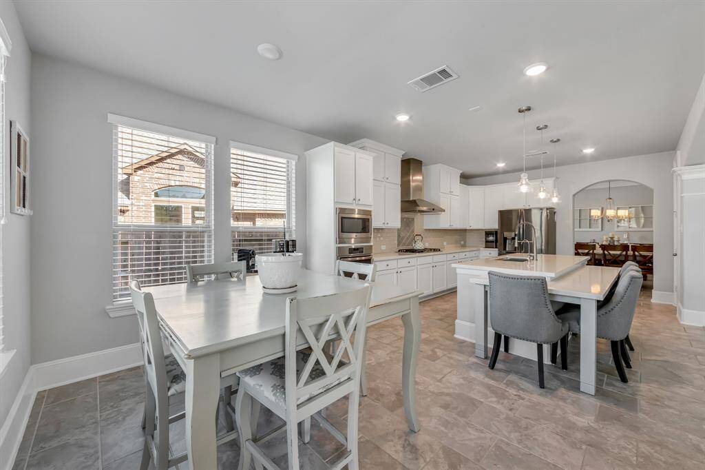 Breakfast area is a relaxing place to have a cup of coffee while viewing your backyard oasis.