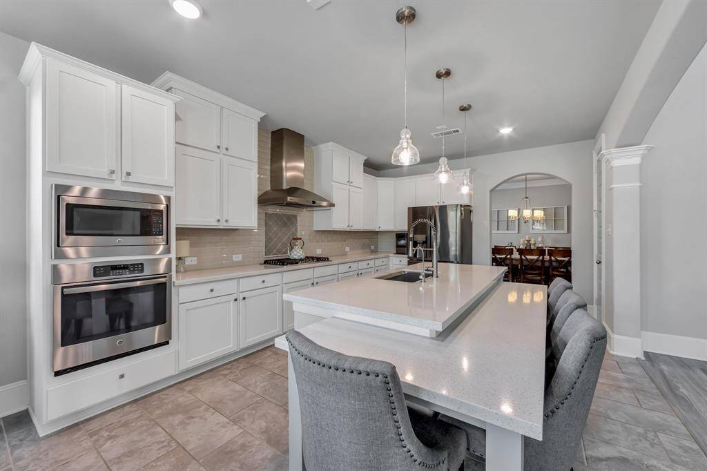 Stainless steel appliances, exquisite backsplash gives this kitchen a top notch look of class.