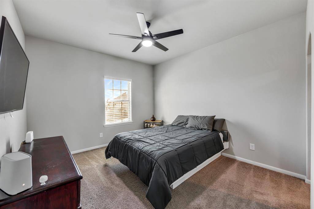 Secondary Bedroom has carpet, ceiling fan and nice size closet.