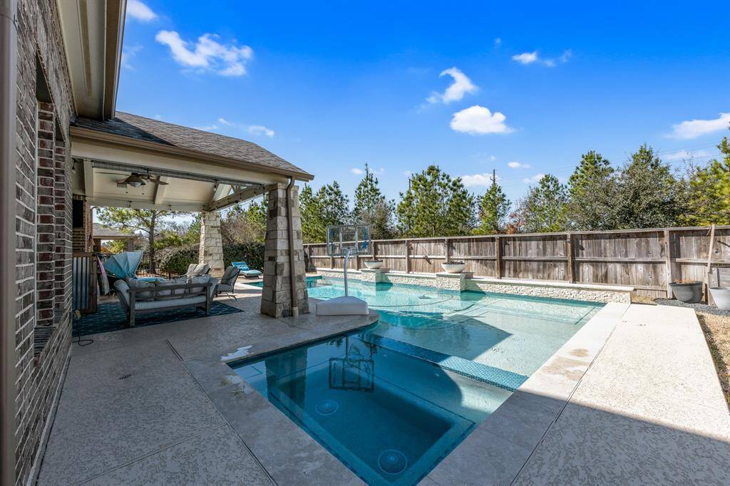 Check out this beautiful L- shaped pool and spa featuring three waterfalls.