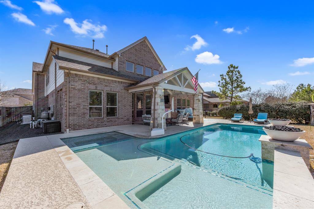 Pool features two fireplace bowls, lounge seating area and spa. This setting provides the perfect place to rest and relax.