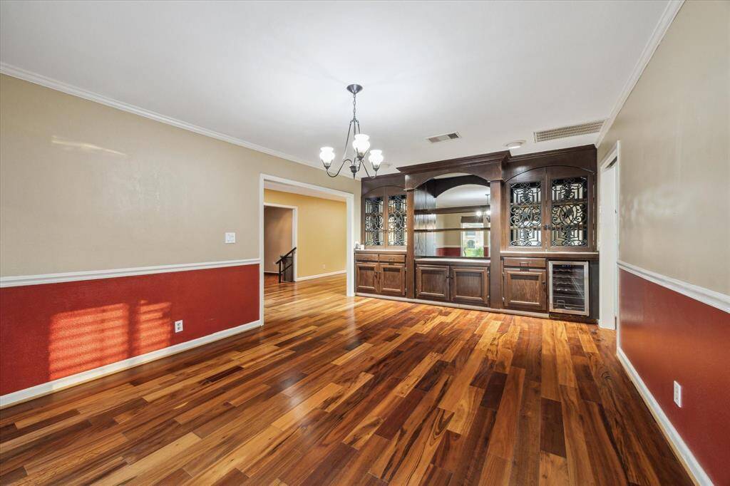 Perfectly located between kitchen and resort-style back patio, this room overlooks the atrium with a classic 3-tier fountain.  Remote control shades can be lowered for privacy.