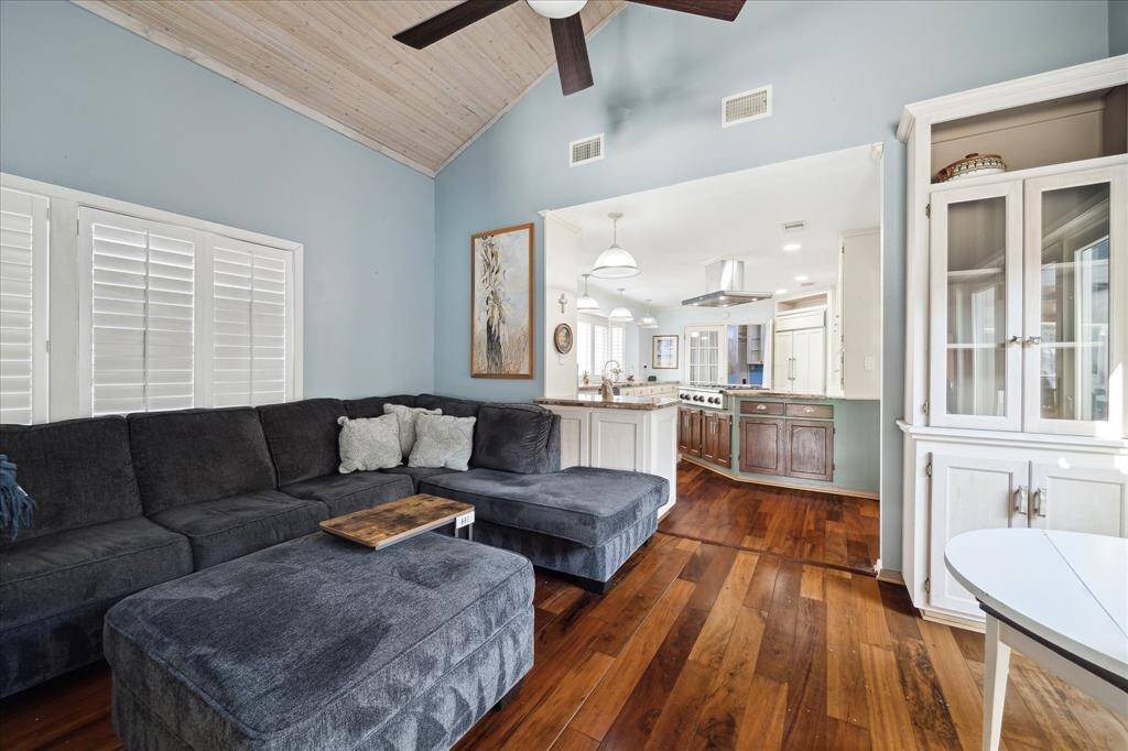 This show-stopping ensuite features a luxurious jetted tub, wooden cabinetry, dual sinks, private water closet, and a large vanity area. Armoire offers additional closet and storage space.  There is an additional walk-in closet as well.