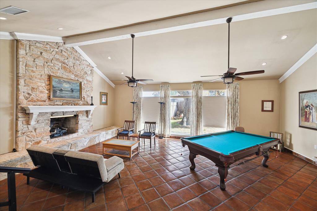 This cozy living room features a high ceiling with a rustic floor-to ceiling stone . Off camera to the right is the wet bar with a custom sink and granite counters. This room is PERFECT for entertaining