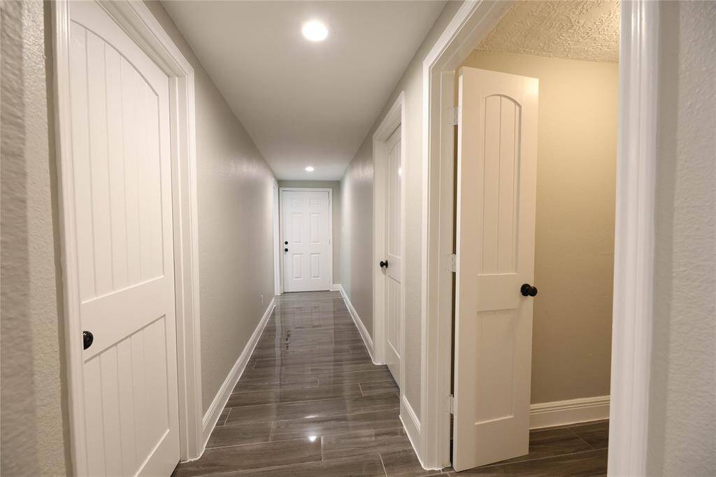 Secondary bedrooms, laundry room & bathroom are tucked away in the back hallway.