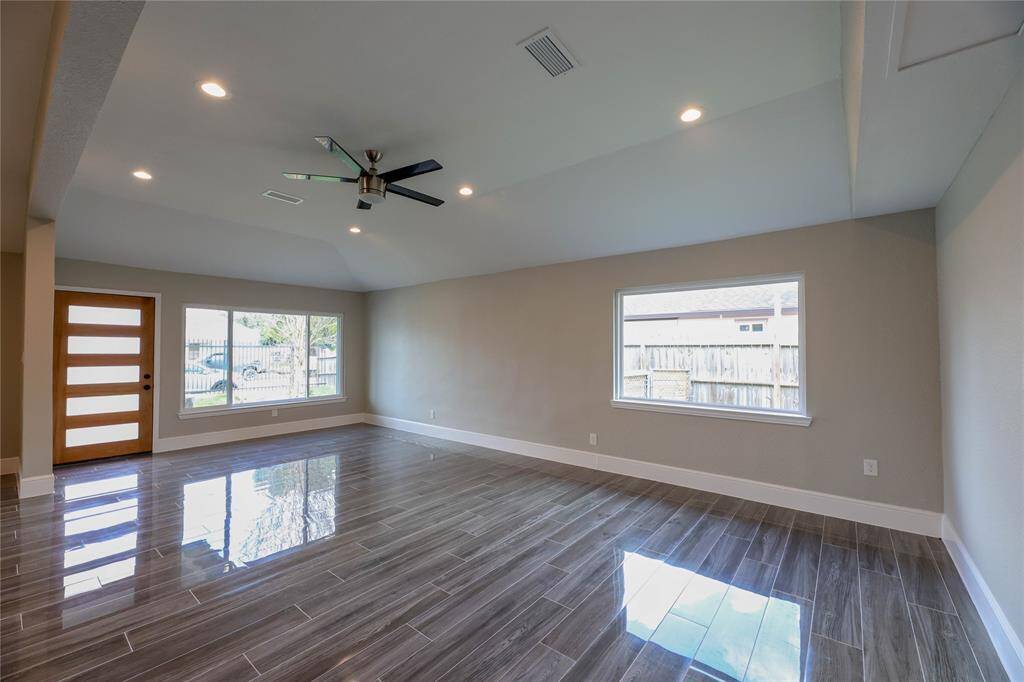 Enter through a sleek mid-century Front entry and into the open Family Room. Large windows allow for natural light to fill the room. Furniture layout possibilities are endless.