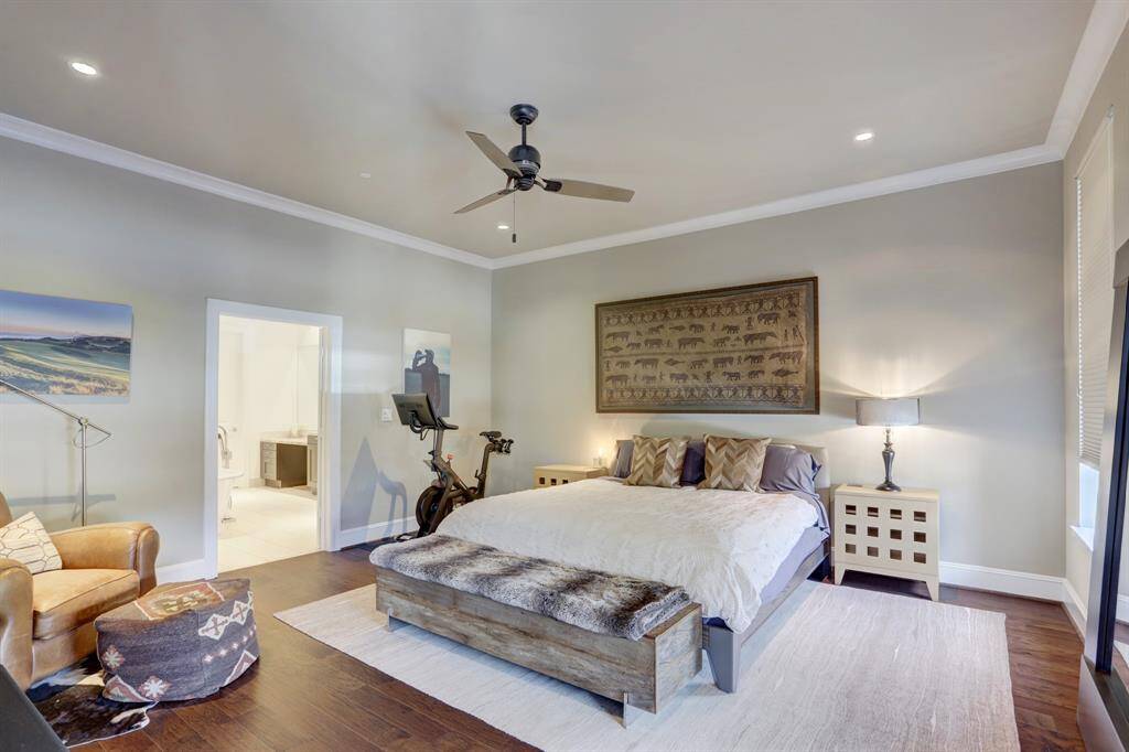 Spacious primary bedroom features hardwood floors, beautiful views and surround sound speakers.