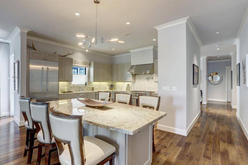 Spacious kitchen with a large island that seats 6! This space features Thermador appliances, ample storage and open concept to the living room.