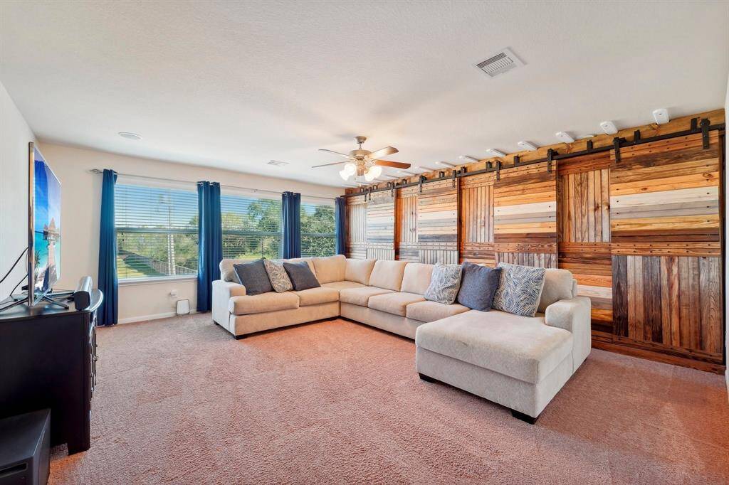 Upstairs gameroom - behind the wooden barn doors is ALL storage!