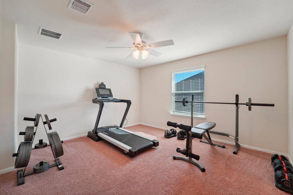 Bedroom 2 is a home gym in this photo