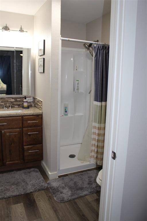 Seperate vanity, Corner shower and toilet complete this full bath. Stackable washer and dryer here, for doing laundry after an "A"mazing day on the water.