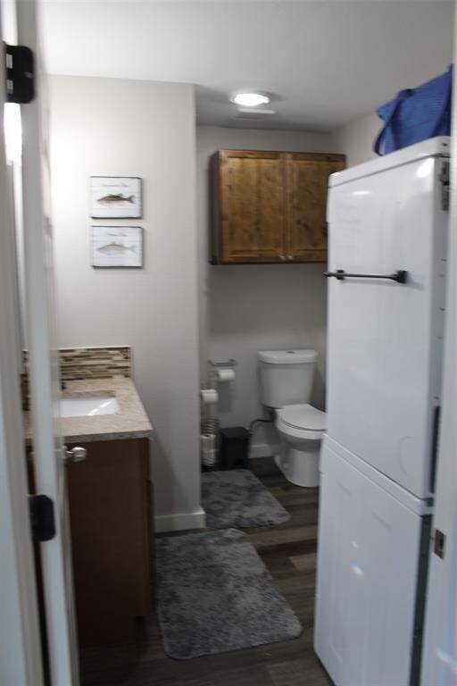 Entry door from main living area, showing stacklable washer and dryer on right.