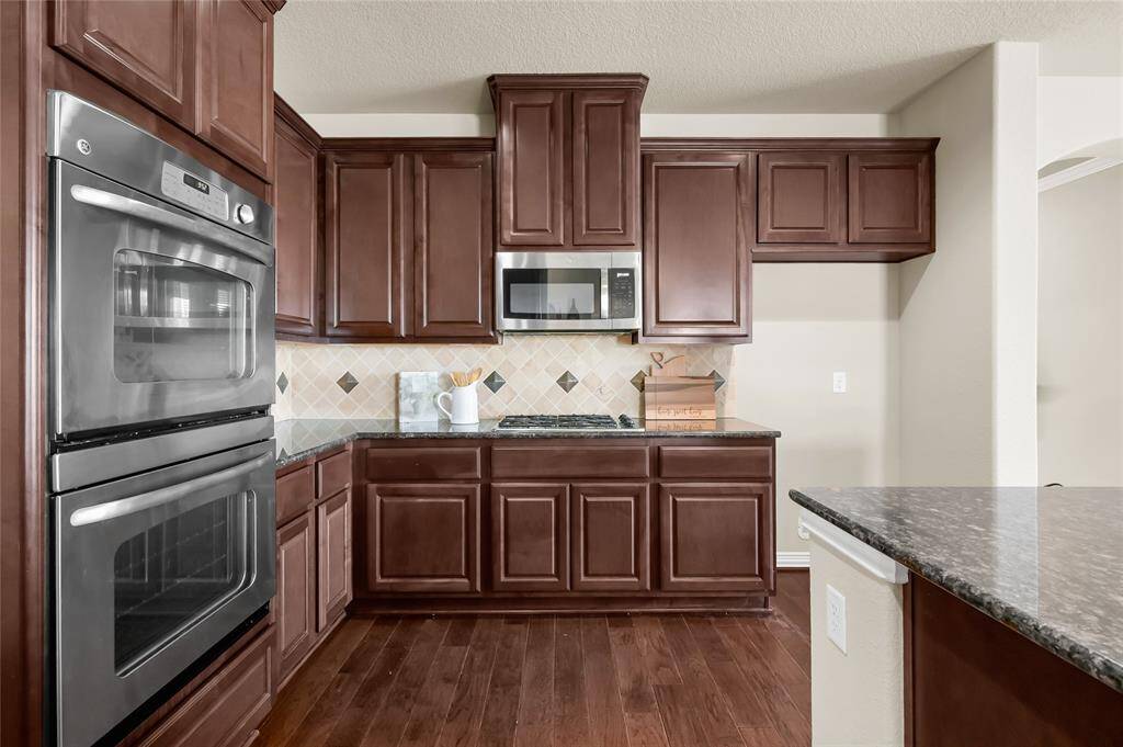 Cooking will be a dream in this kitchen with a double oven and gas stovetop