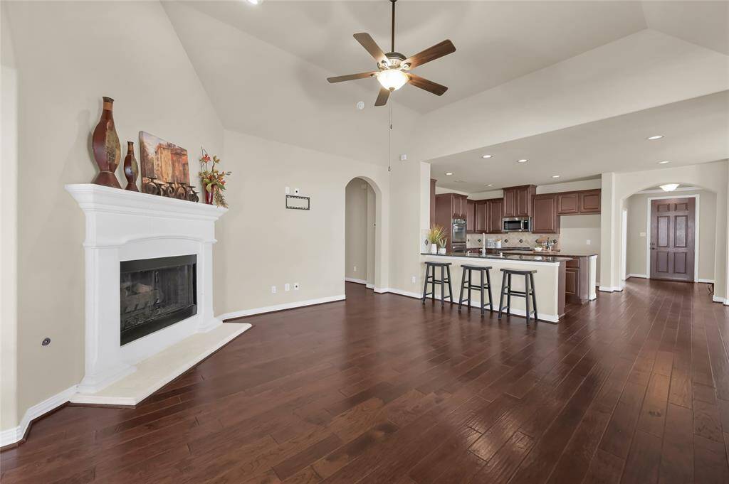 The kitchen also features a breakfast bar, open to the living room. Perfect for entertainment and keeping your eyes on the big game!