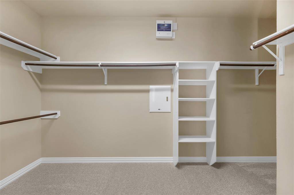 Large walk-in closet includes built in shelving!