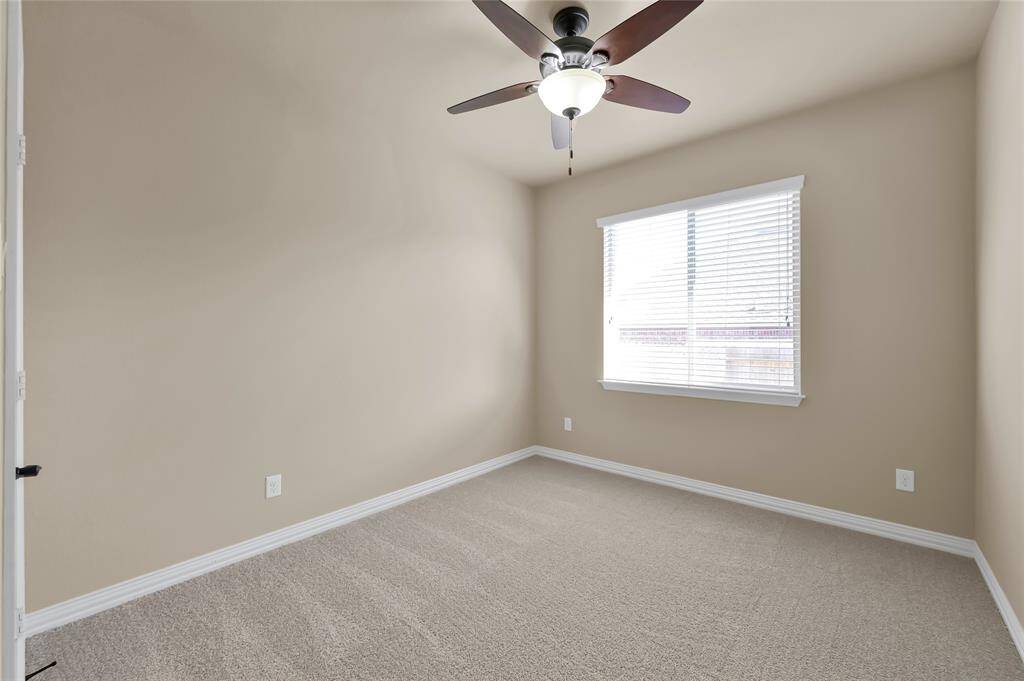 4th bedroom, with plush carpets, and a built in ceiling fan