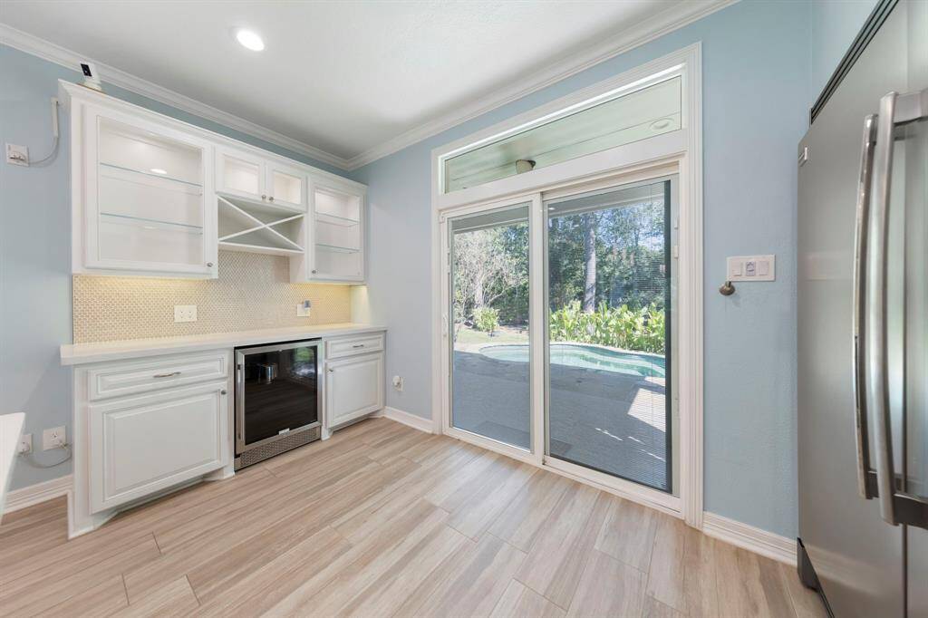Built-in buffet with serving bar and beverage refrigerator as you exit to the backyard oasis!