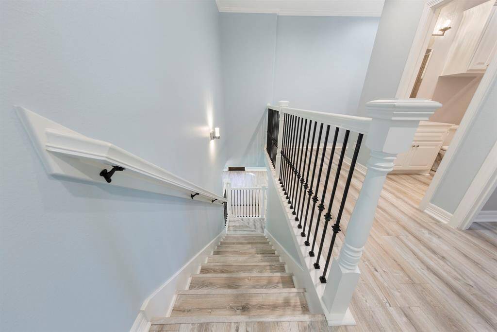 New luxury vinyl plank flooring extends from the stairs throughout the entire upstairs, providing a stylish and durable finish.