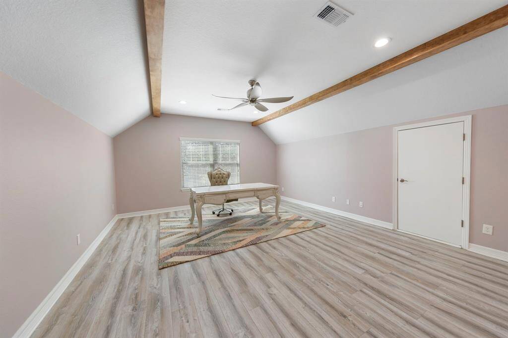 This expansive 18x16 flex space above the garage offers incredible versatility, perfect for a home office, game room, playroom, media room, or extra storage. Enhanced by wood beams on the ceiling and ample attic storage, it combines style and functionality seamlessly.