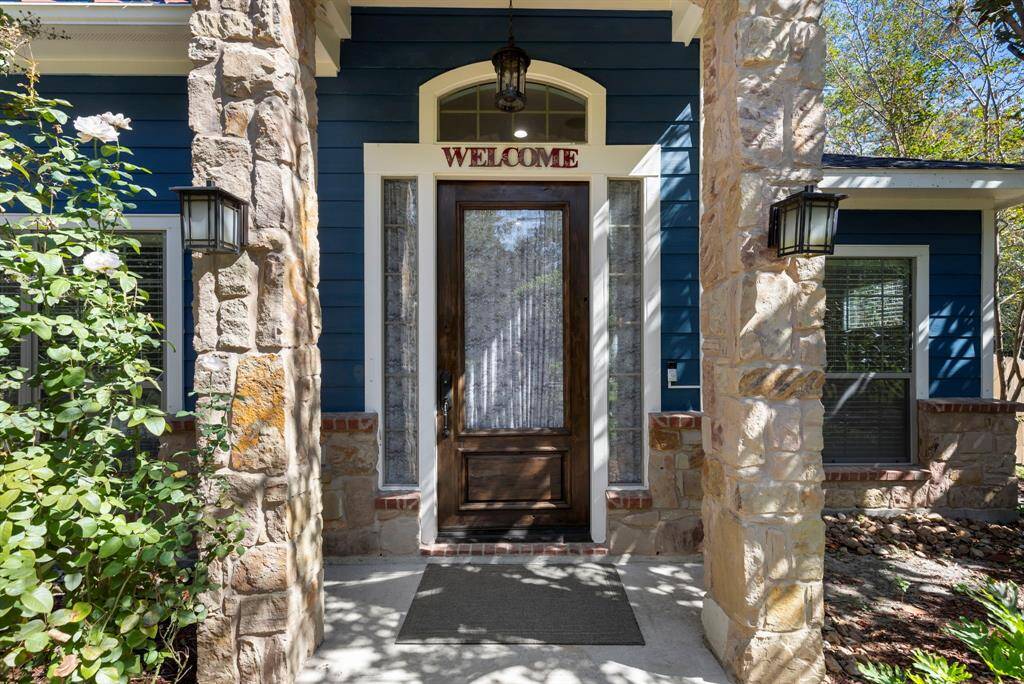 The exterior features a stunning combination of stone and hardy plank, highlighted by a soaring high front door that creates a grand and inviting entrance.