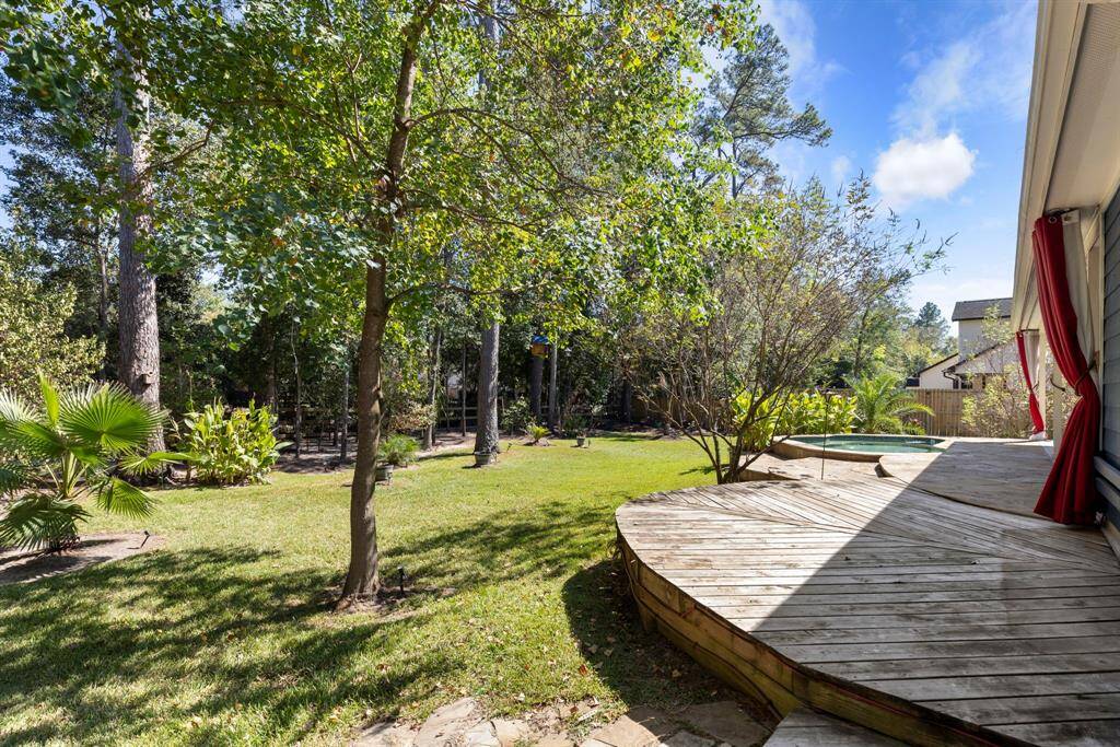 Additional decking extends along the side of the house, providing extra space for lounging or outdoor activities.
