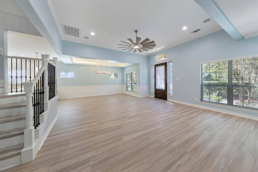 The living room effortlessly flows into the dining area, creating a seamless space perfect for both relaxation and entertaining.