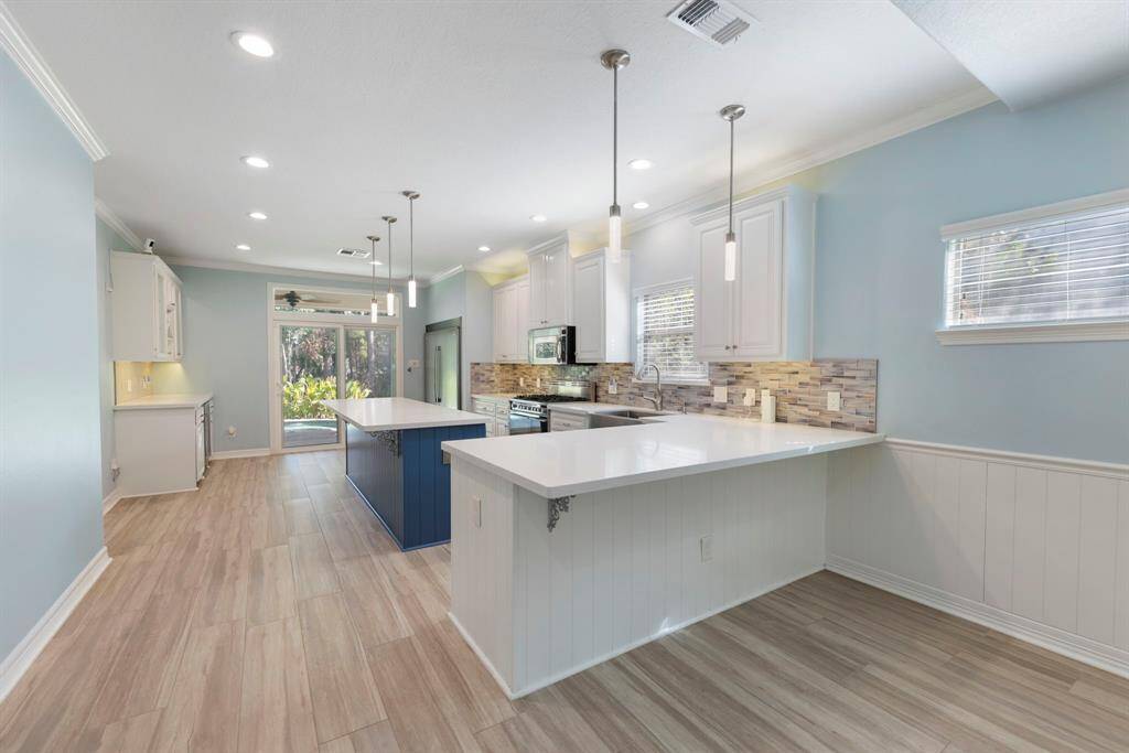 Step into your chef's dream kitchen, which boasts two breakfast bars and a spacious quartz island, perfect for culinary creations and casual gatherings.