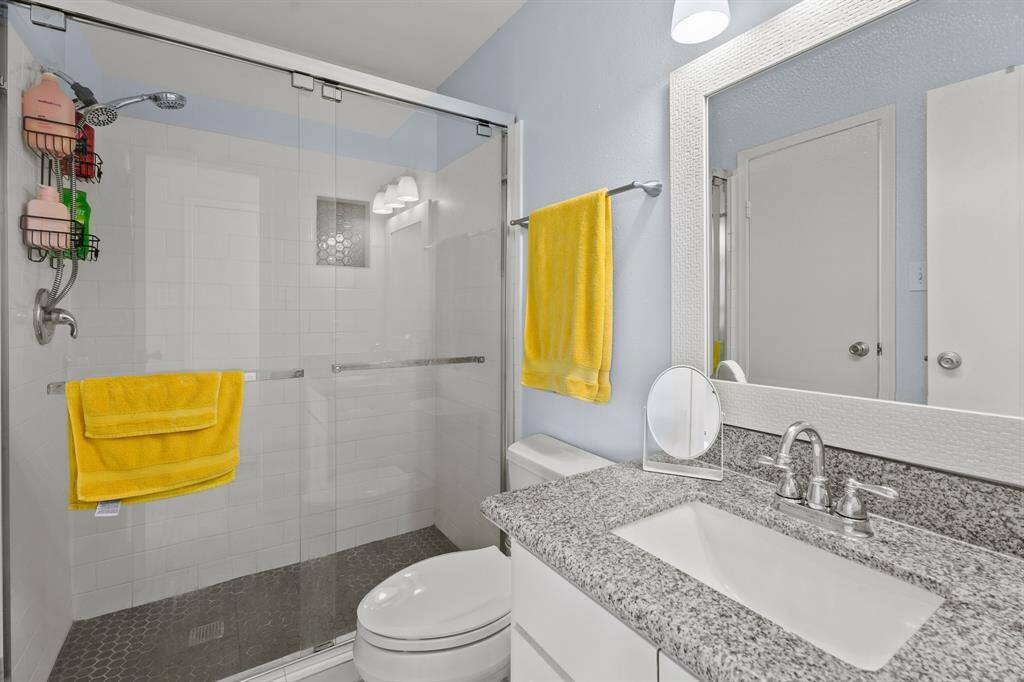 The bathroom is bright and cheery and features the large shower.