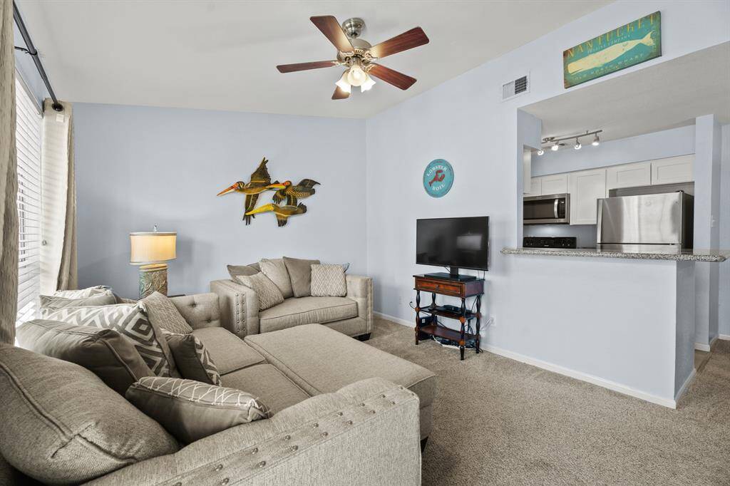 You enter the condo into this cheerful living space ...