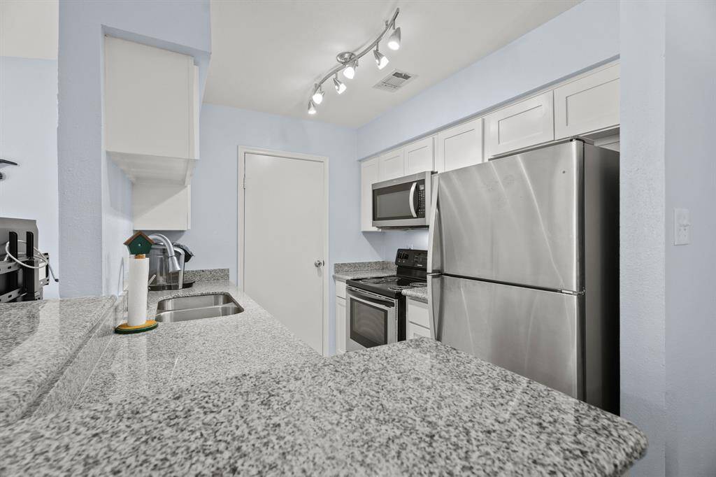 ... the beautifully remodeled kitchen.  The door leads to the utility room.