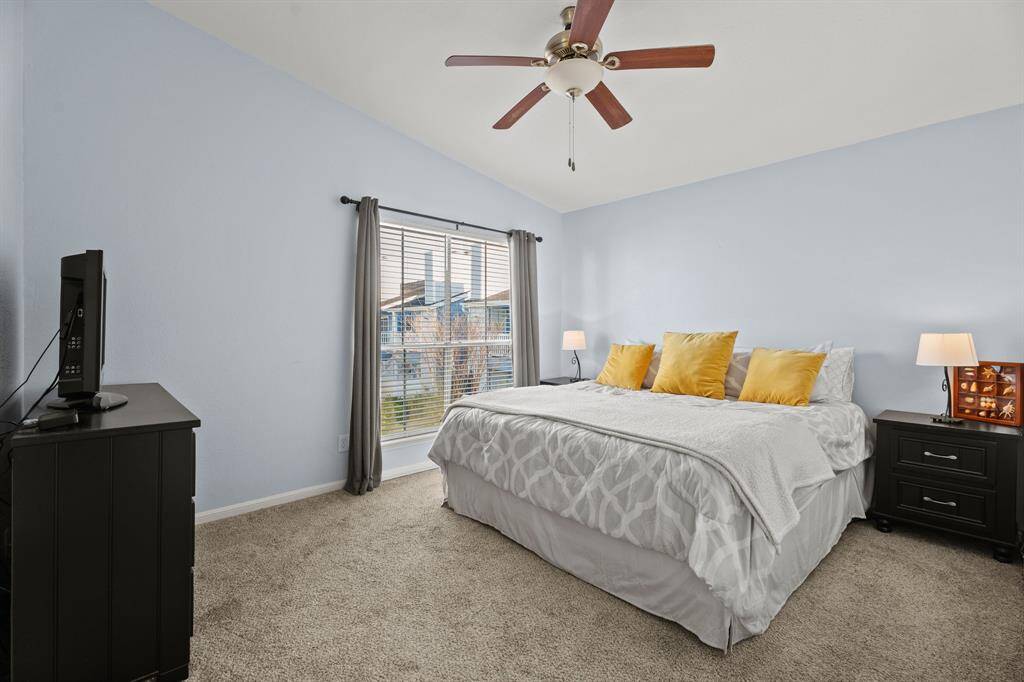 The primary bedroom is spacious, and the vaulted ceiling makes it feel even more spacious.
