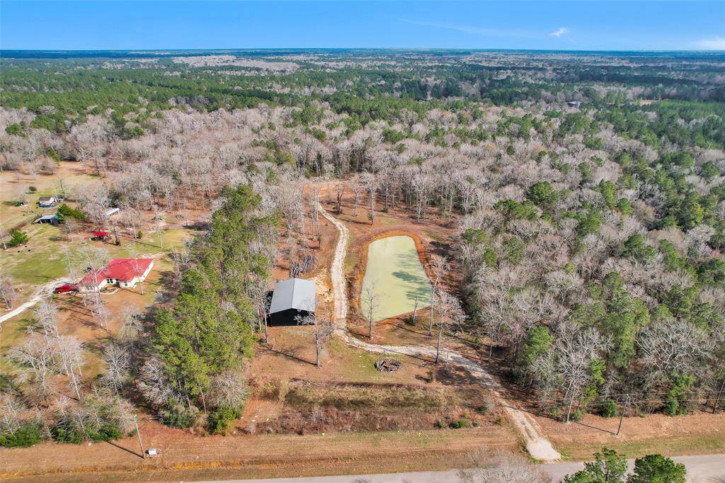 Come home to this beautifully secluded paradise in the woods. 21+ acres with pond, 40x60 shop with 14' doors, driveway, and a pad site waiting for your dream home.