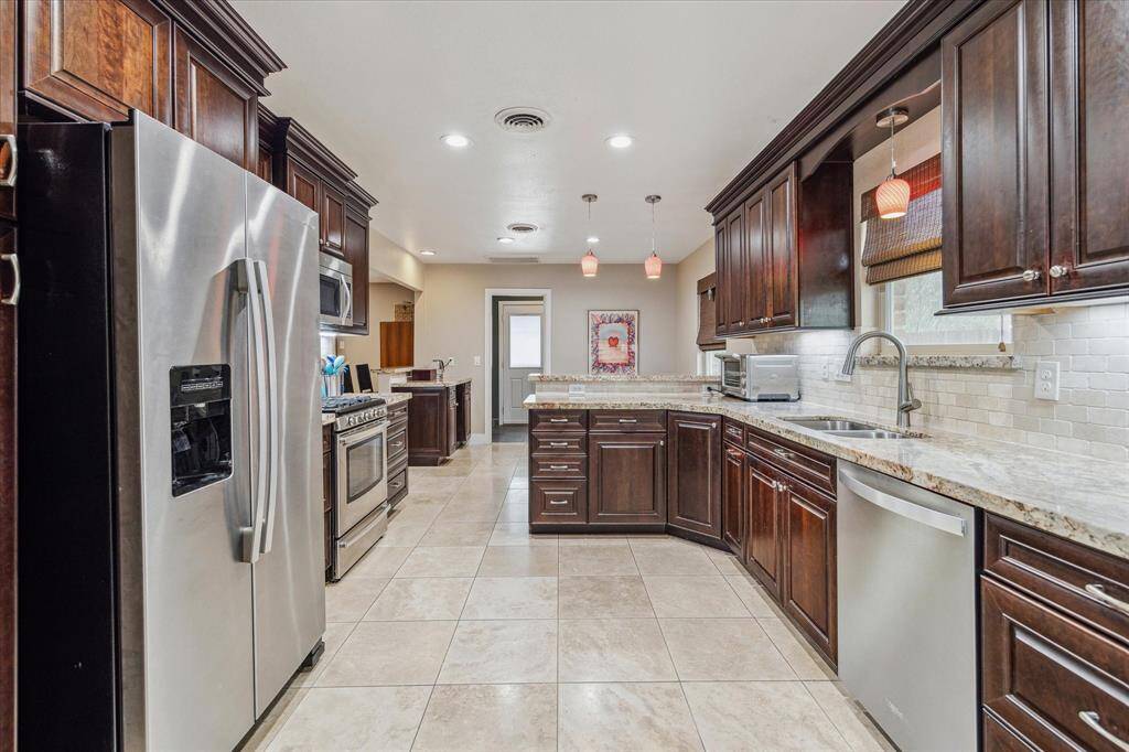 Pendant lighting, and cooking with gas and lots of natural lighting
