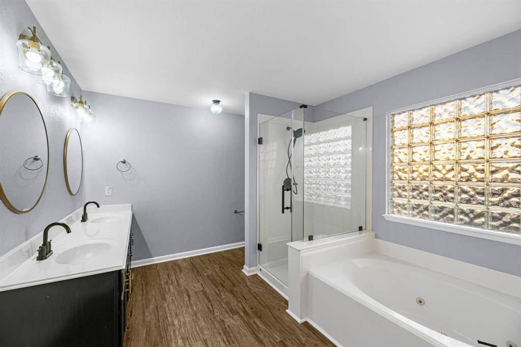 Ensuite Bathroom: Soaking tub, Shower with new seamless glass surround.