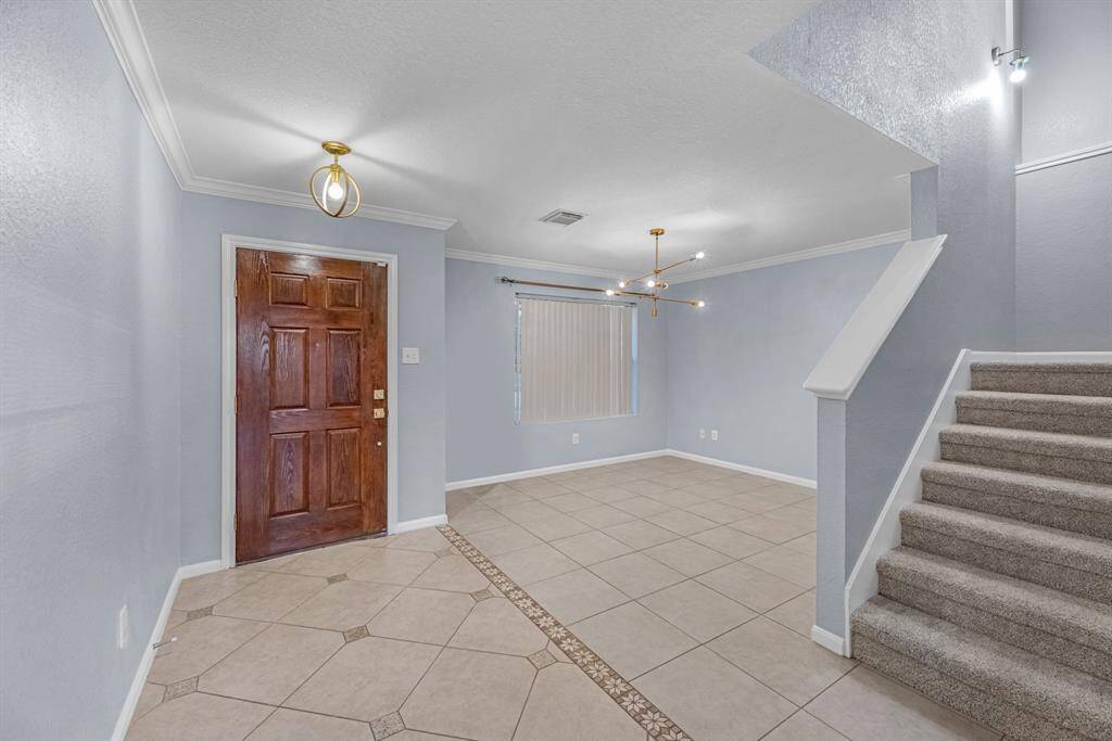 Inviting Entry with neautral tile floors.
