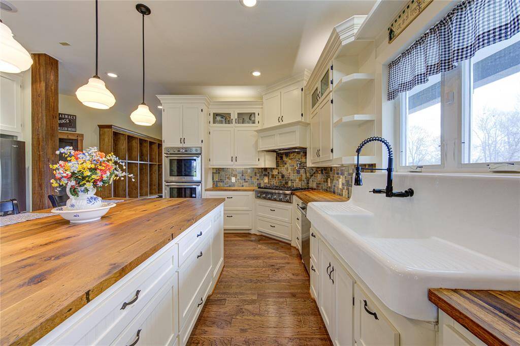 Appliances include a Thermador stainless professional double oven, propane gas range top and dishwasher and pot filler for ease of meal preparation.