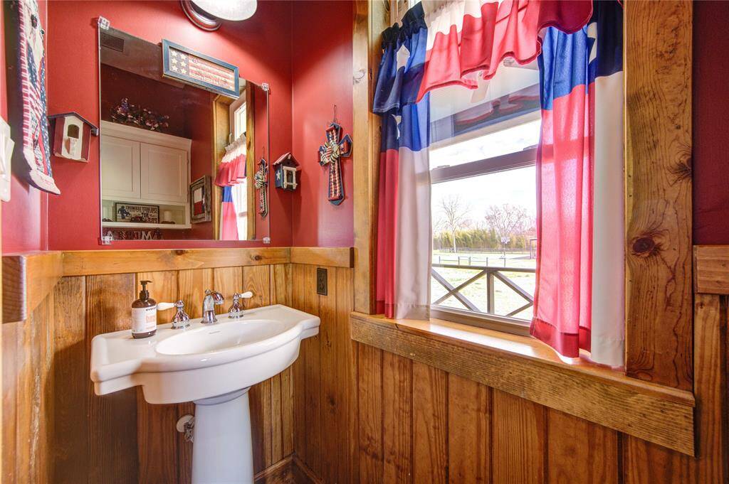 Half bath located off of the laundry room with large window and natural light.