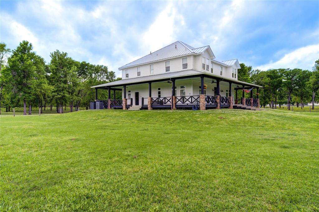 This charming two-story home features a classic design with a large fully wrap-around porch. Set against the backdrop of an exquisite 10 acre park-like property, it's a must see! Ideal for enjoying serene views and outdoor relaxation.