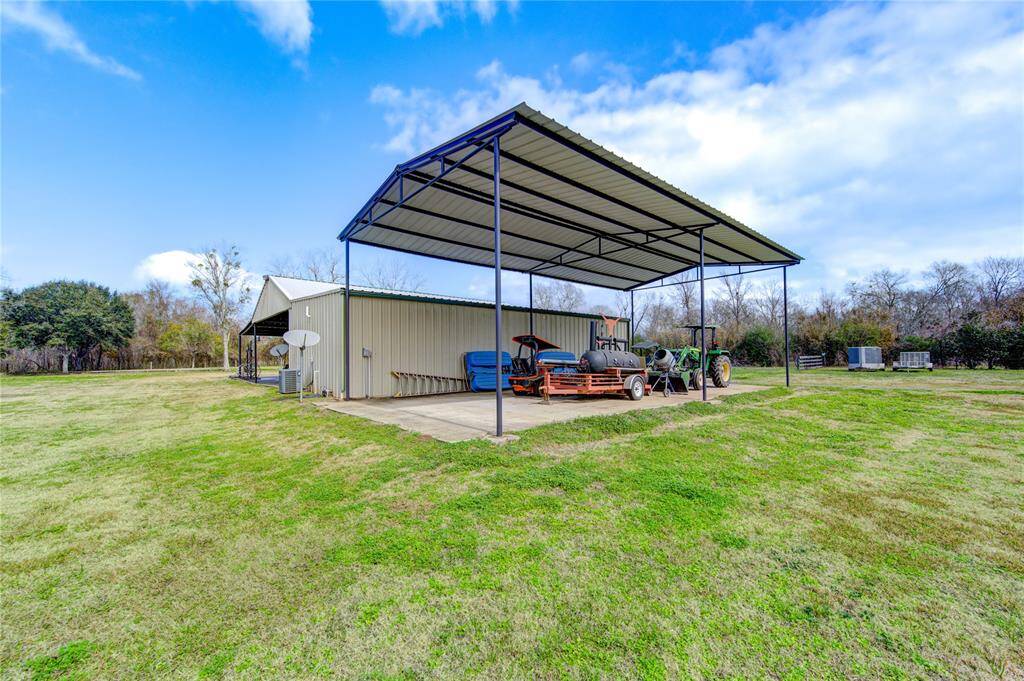 The detached dwelling features a covered RV parking on concrete slab with full 50 amp hookups,