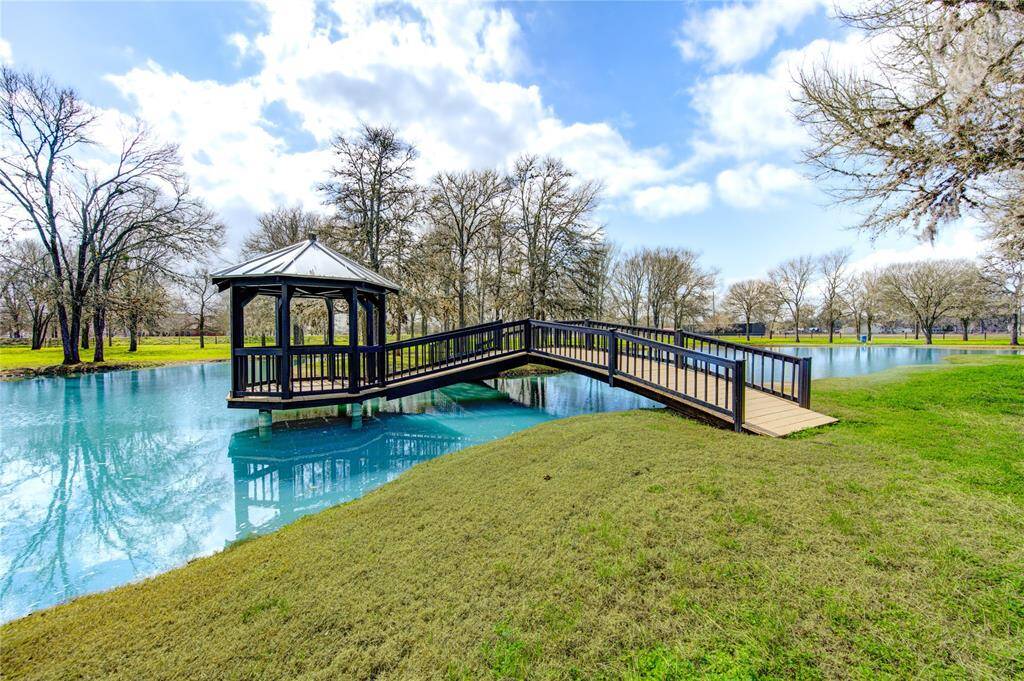 Enjoy relaxing or entertaining on your own property. This amazing bridge and gazebo offers a tranquil setting.
