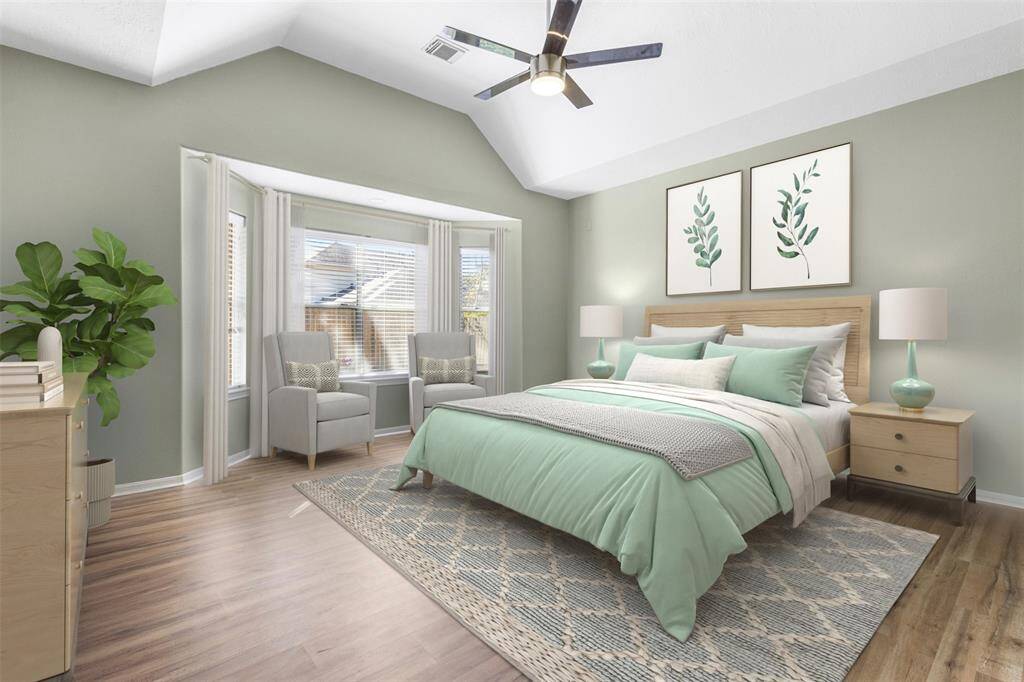 Virtually Staged- Spacious primary bedroom located on the first floor.