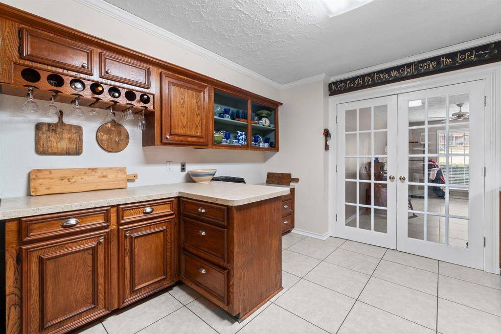 Wine rack and island bar with ample drawer space and built-in desk space under the open shelves.
