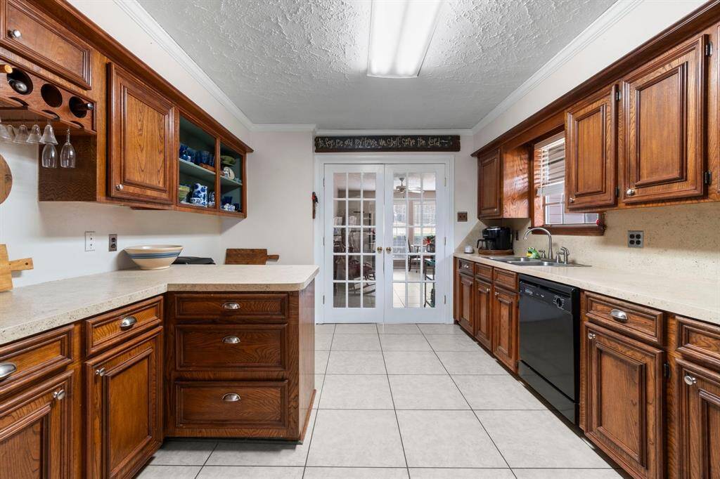 Ample space for cooking or baking and a few open shelving.  The flex/sun room is just beyond the french doors.