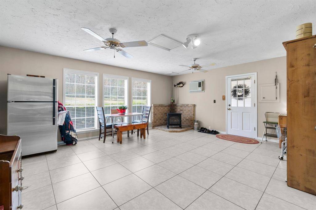 So many options for this flex room that has it's own A/C-heater wall unit and electric fireplace.