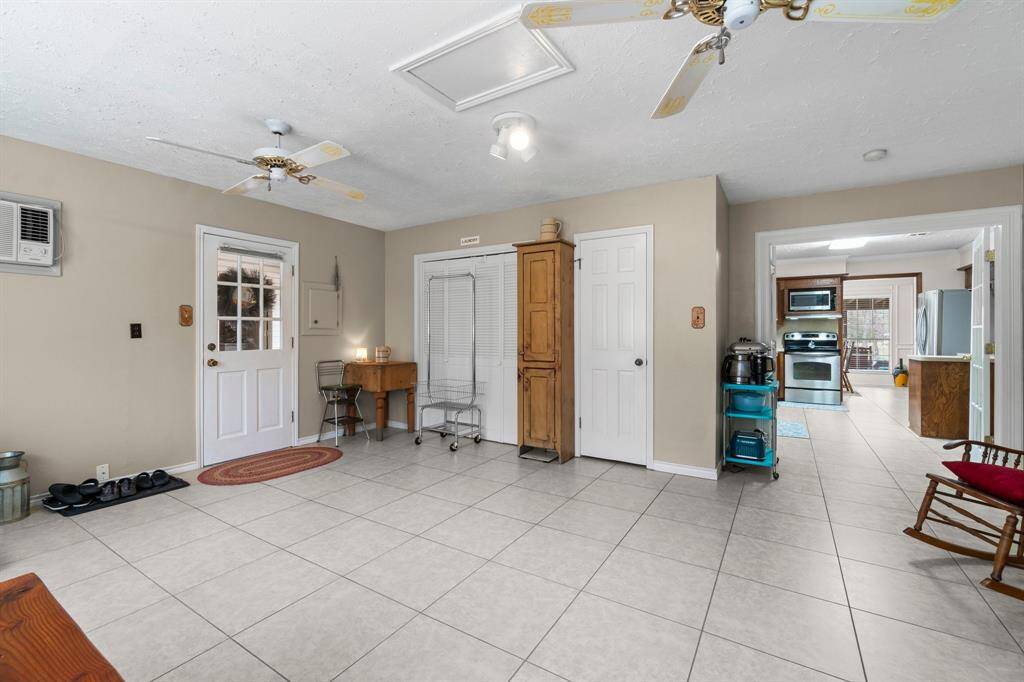 The flex/sun room houses the laundry and has a walk in closet/pantry.  The side door leads outside to the atrium/carport and to the garage & guest quarters.
