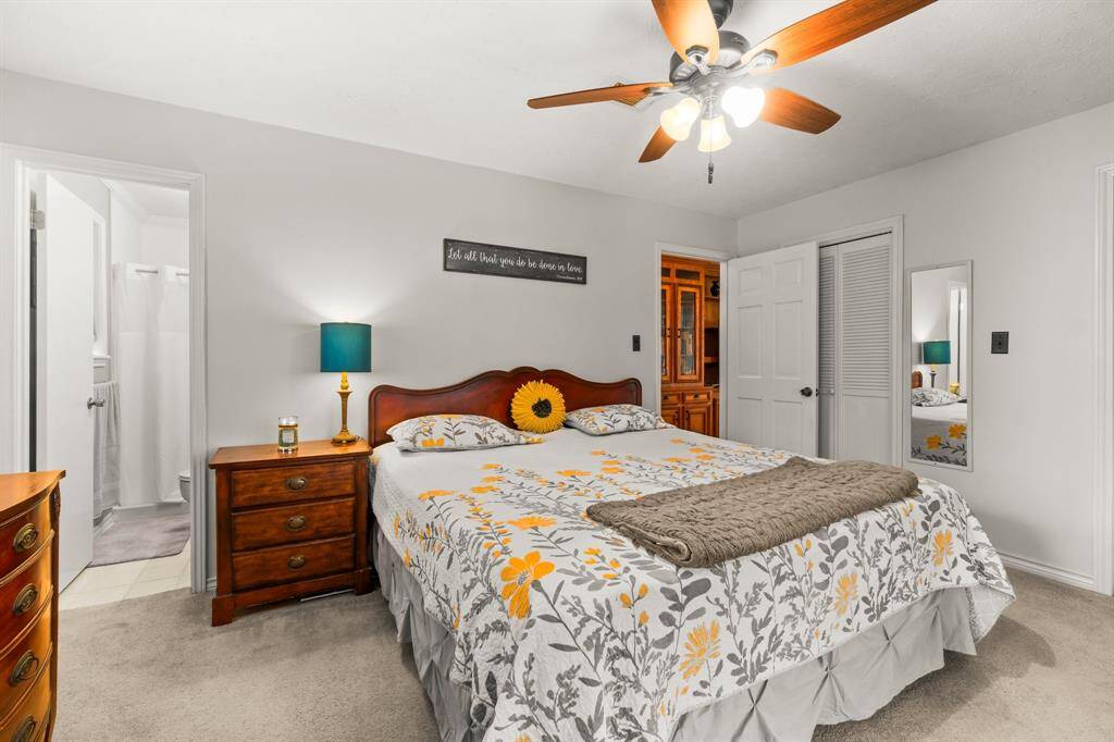 Primary Bedroom with a wall of closet space that includes two access doors.