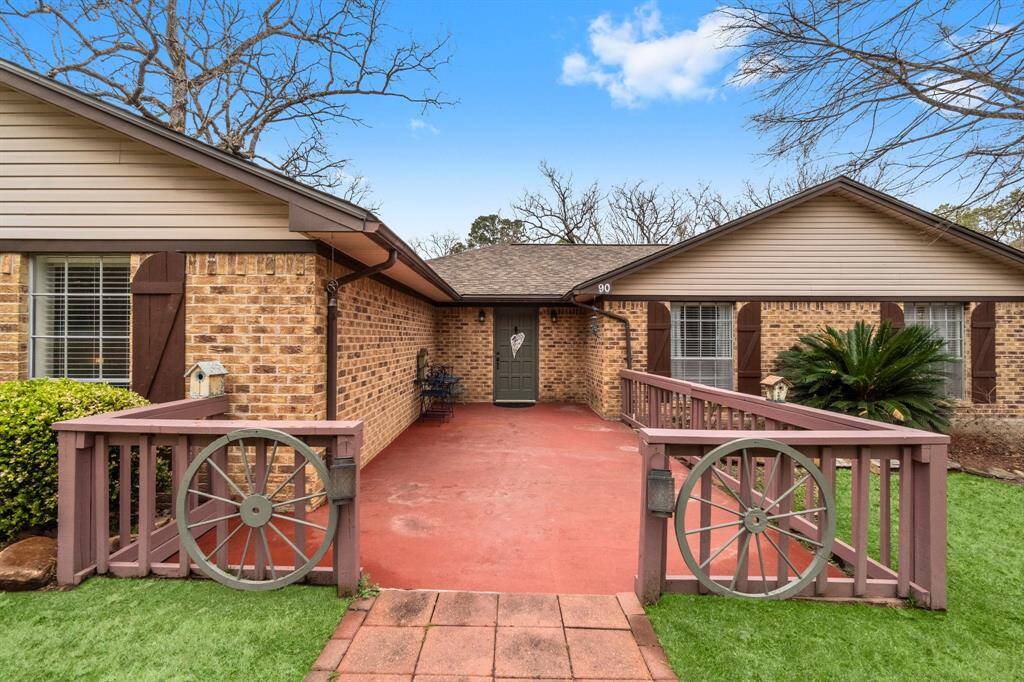 Well maintained brick home with spacious concrete front porch, stylish shutters and gutters on the home.