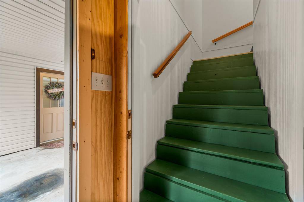 Stairs just inside the garage that lead to the guest quarters.