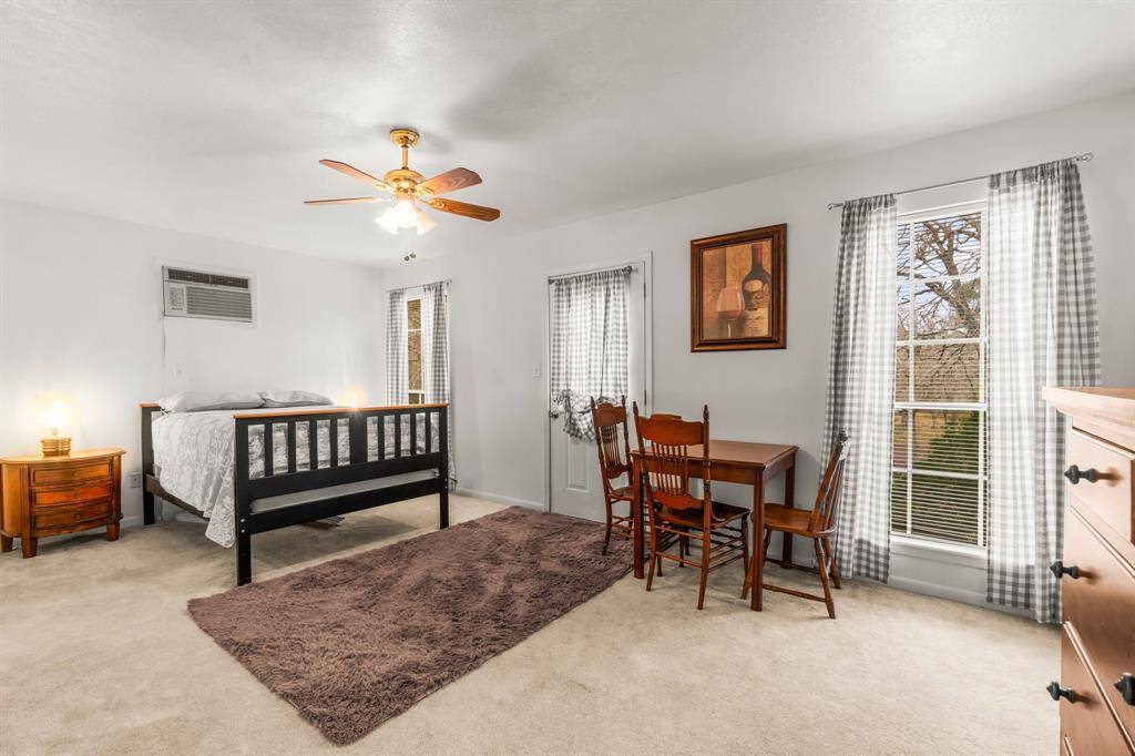 Just up the stairs and to the right you will find this oversized bedroom with an exterior door that opens out to the balcony that overlooks the backyard and water.