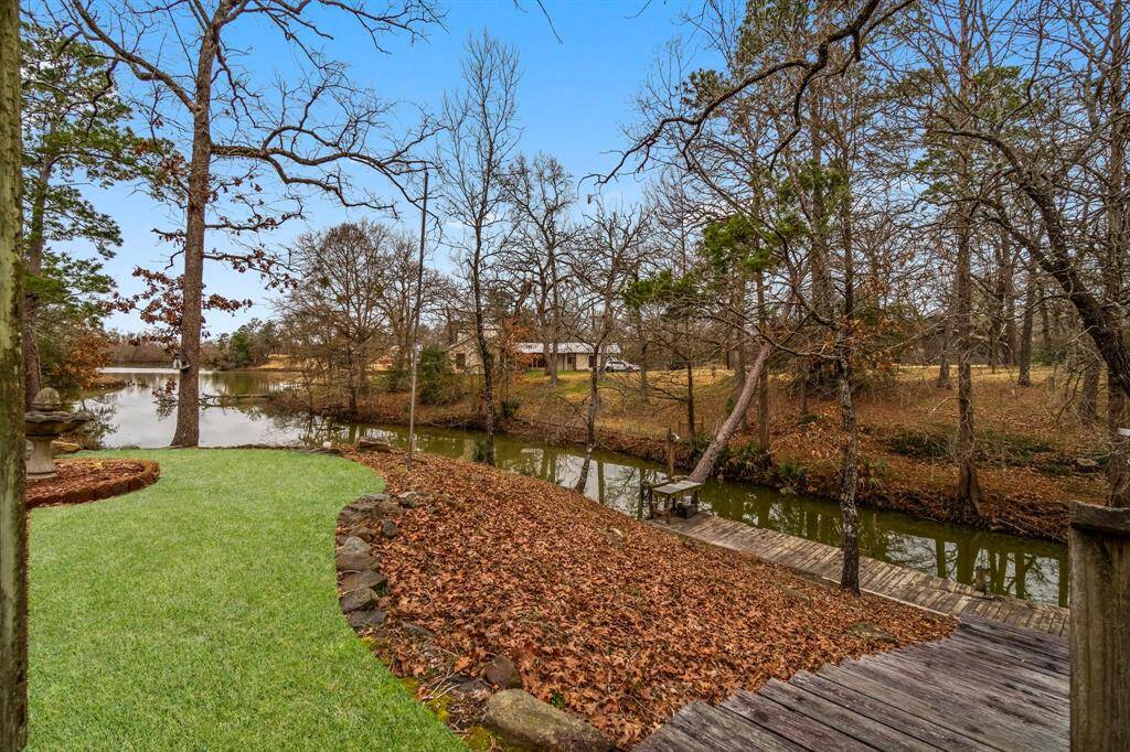 Nicely landscaped backyard down to the water; fish cleaning station with light and water.